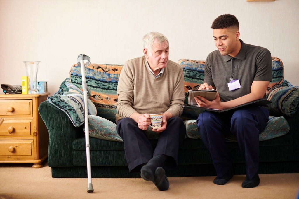 Man and personal assistant on sofa